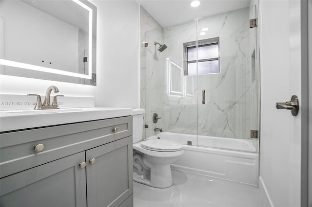 full bathroom with vanity, toilet, and bath / shower combo with glass door