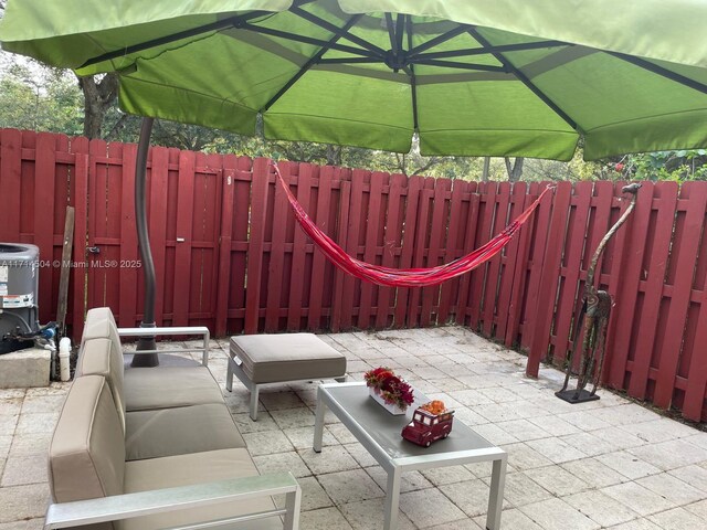 view of patio with outdoor lounge area and central AC unit