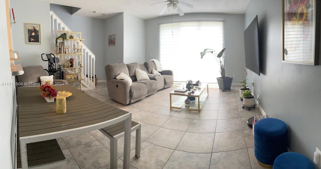 living room featuring ceiling fan and light tile patterned flooring