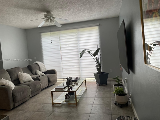 tiled living area featuring a textured ceiling and ceiling fan