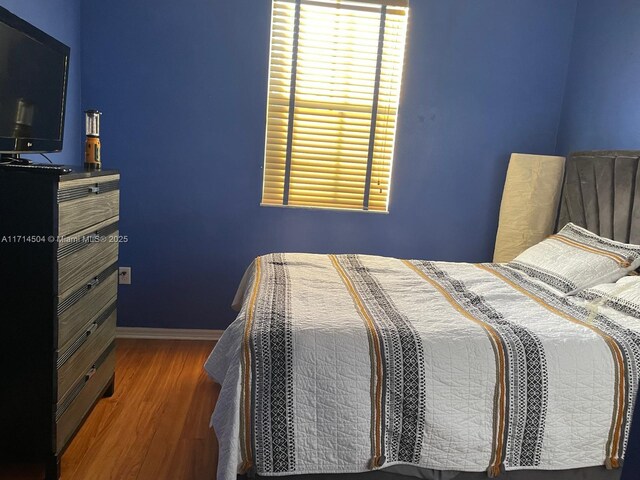 bedroom featuring dark hardwood / wood-style flooring