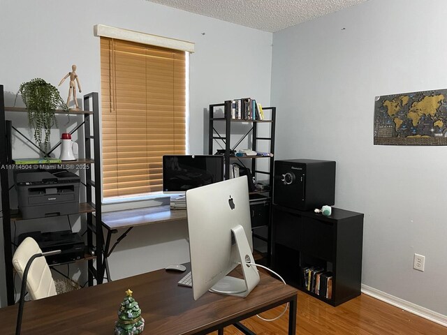 office space featuring hardwood / wood-style floors and a textured ceiling