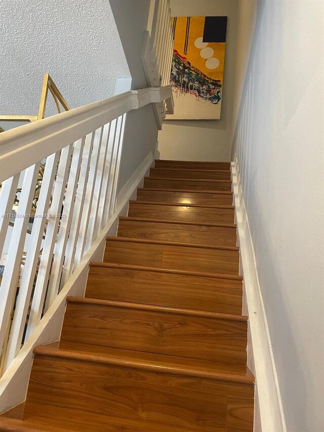 staircase featuring hardwood / wood-style floors