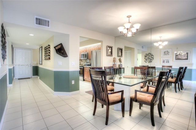 tiled dining space featuring a notable chandelier