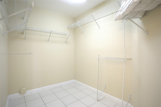 spacious closet with light tile patterned floors