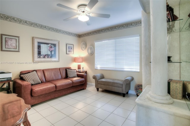 living room featuring decorative columns, ceiling fan, and light tile patterned flooring