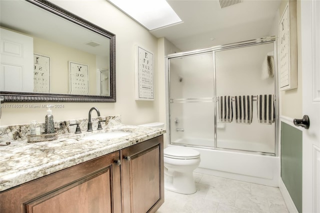 full bathroom featuring vanity, toilet, and combined bath / shower with glass door