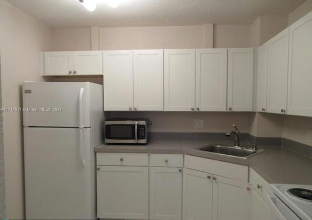 kitchen with white cabinets and white refrigerator