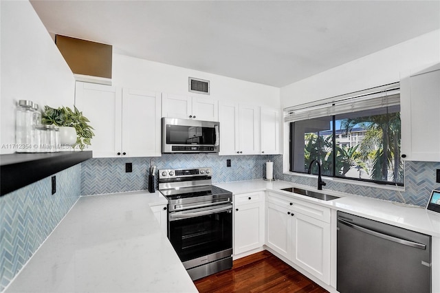 kitchen featuring white cabinetry, sink, and appliances with stainless steel finishes