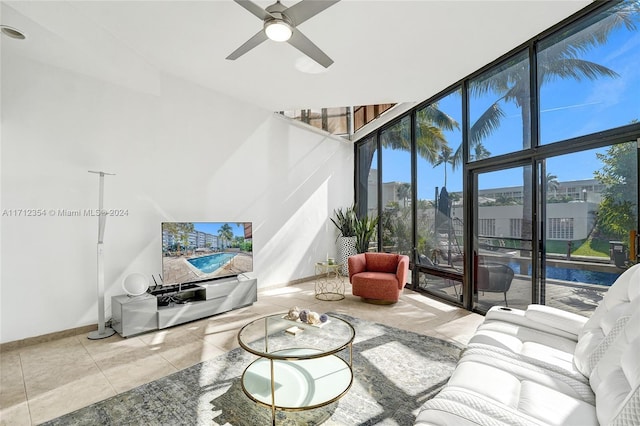 tiled living room featuring floor to ceiling windows and ceiling fan