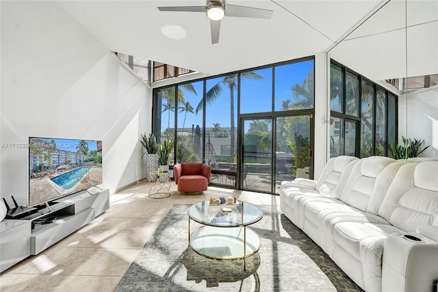 living room featuring tile patterned flooring, ceiling fan, expansive windows, and plenty of natural light