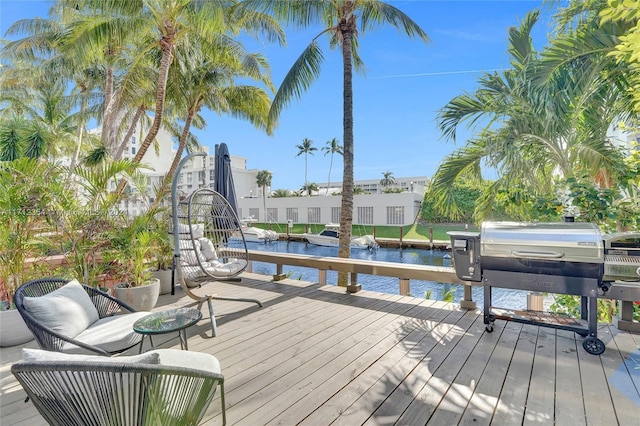 wooden terrace featuring a water view and a dock