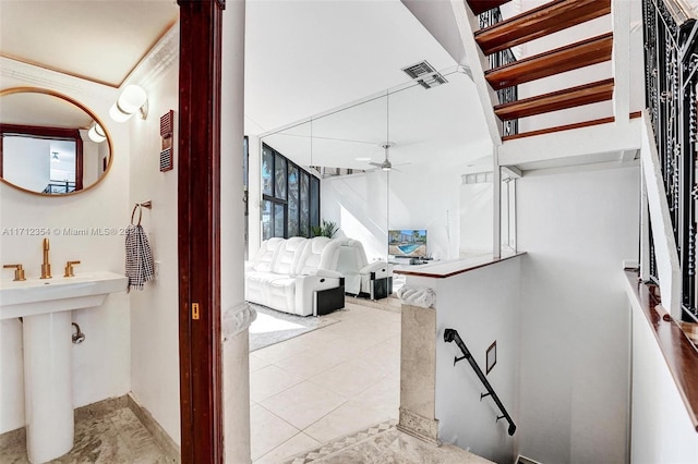 bathroom featuring ceiling fan and tile patterned flooring