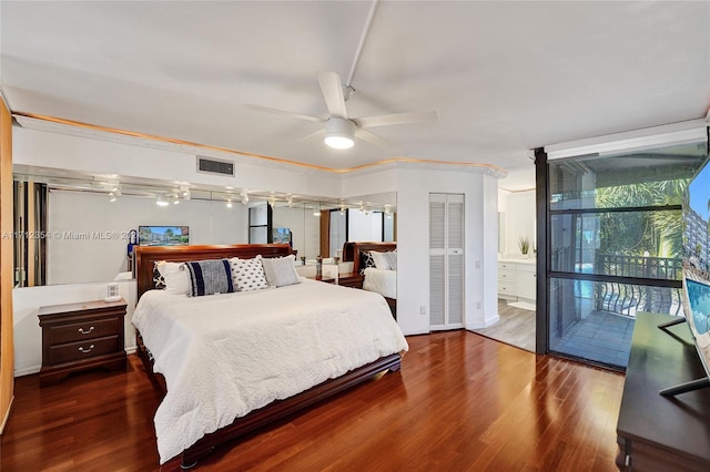 bedroom with ensuite bath, ceiling fan, ornamental molding, wood-type flooring, and a closet