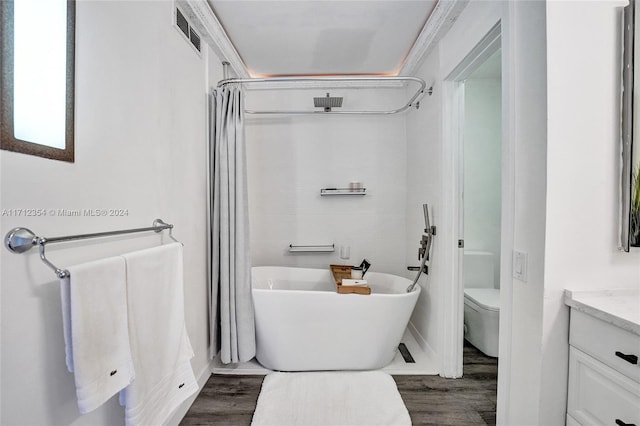 bathroom with hardwood / wood-style flooring, vanity, and toilet