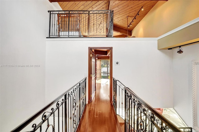 hall featuring hardwood / wood-style floors, wood ceiling, and high vaulted ceiling