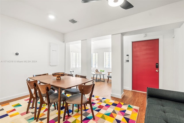 dining space with light hardwood / wood-style flooring and ceiling fan