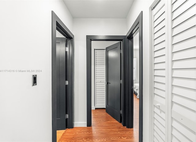 hall with light hardwood / wood-style floors