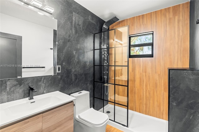 bathroom with vanity, toilet, tile walls, and walk in shower