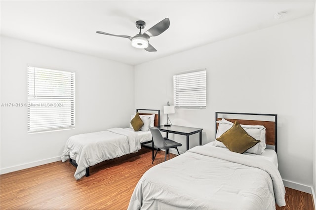 bedroom with ceiling fan and wood-type flooring