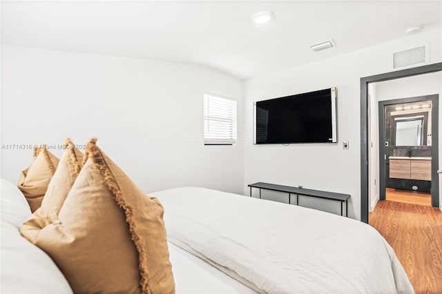 bedroom with hardwood / wood-style flooring