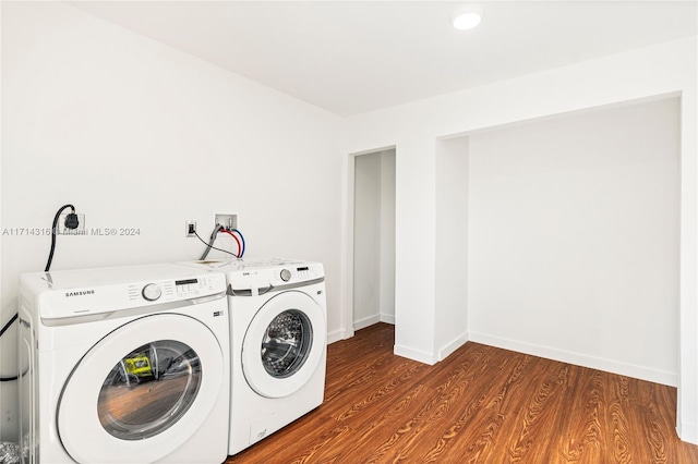 laundry room featuring wood-type flooring and washing machine and dryer