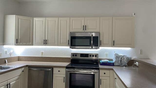 kitchen featuring sink, white cabinetry, and stainless steel appliances