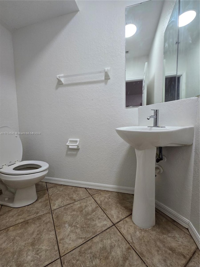 bathroom with tile patterned floors and toilet