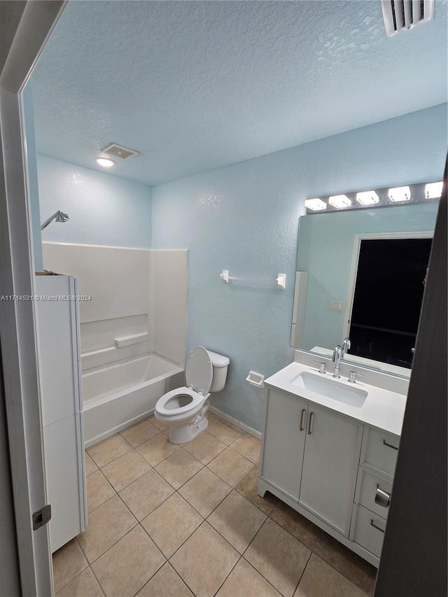 full bathroom featuring tile patterned flooring, a textured ceiling, toilet, vanity, and bathtub / shower combination