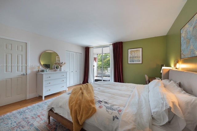 bedroom featuring access to exterior and light hardwood / wood-style flooring