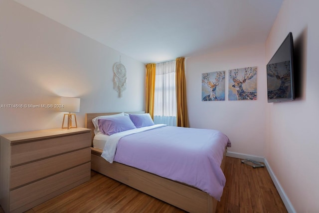 bedroom with hardwood / wood-style floors