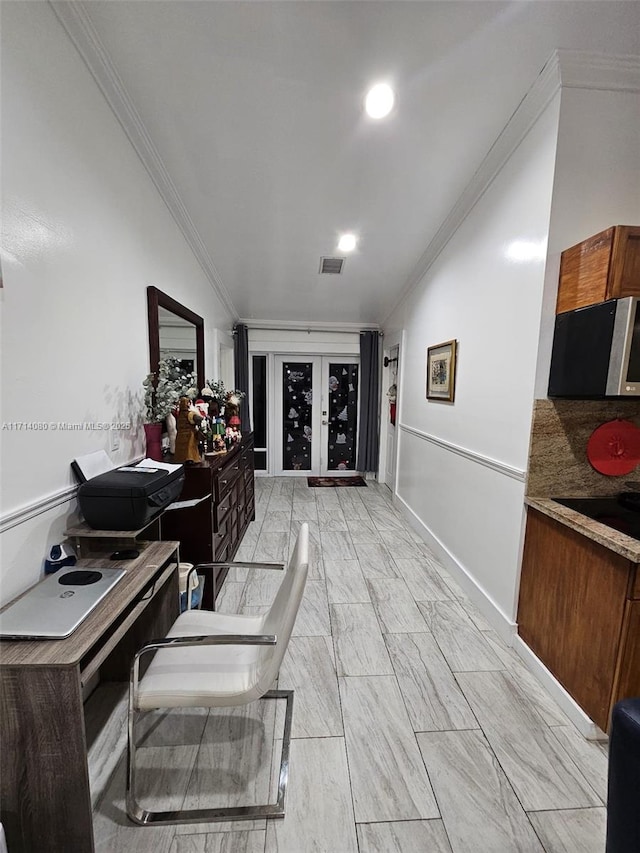 hallway with crown molding and vaulted ceiling