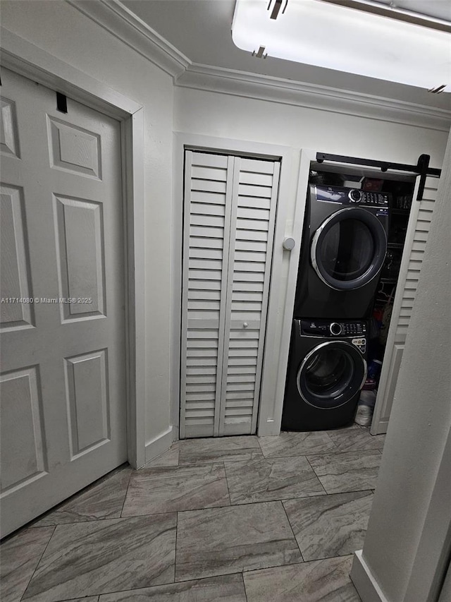 laundry area with ornamental molding and stacked washer and clothes dryer