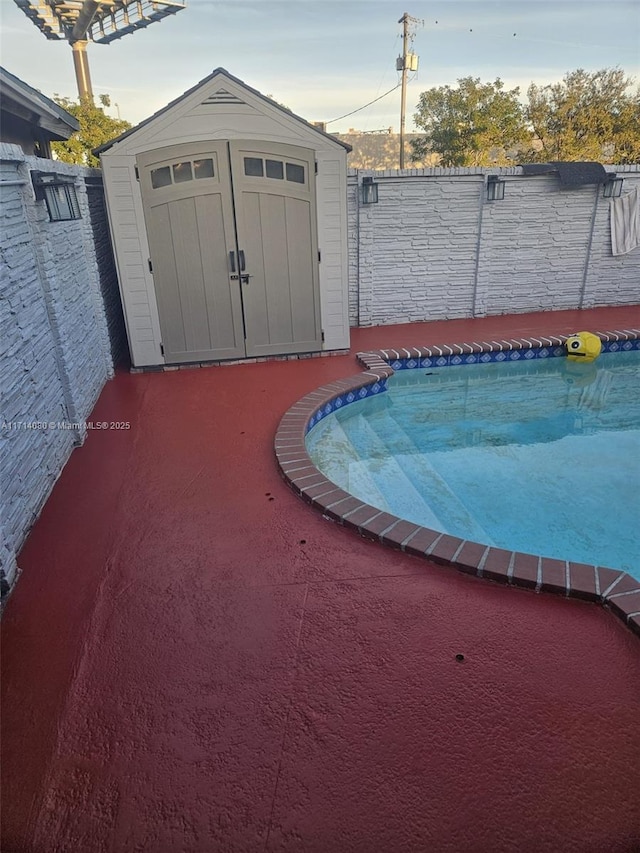 view of swimming pool with a storage shed