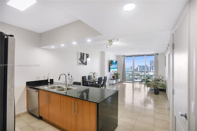 1750 N Bayshore Dr Unit 3210, Miami, FL 33132 - kitchen with stainless steel dishwasher, a peninsula, open floor plan, dark countertops, and light tile patterned flooring