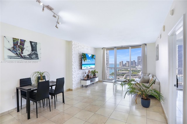 dining room featuring a wall of windows and light tile patterned flooring