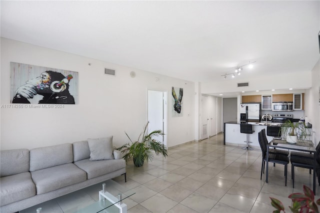 living room with sink and light tile patterned flooring