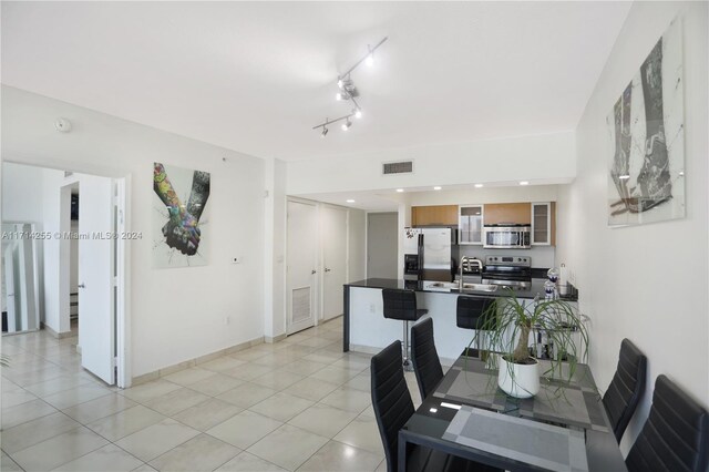 dining space with light tile patterned floors