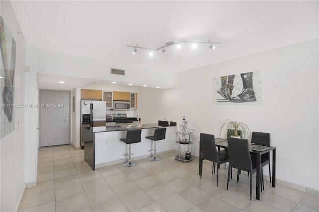 tiled dining room featuring sink