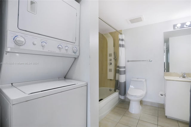 washroom with stacked washer / drying machine, light tile patterned floors, and sink