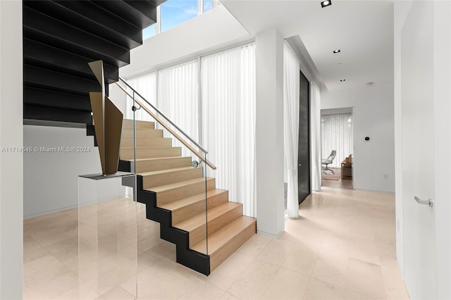 staircase featuring tile patterned flooring