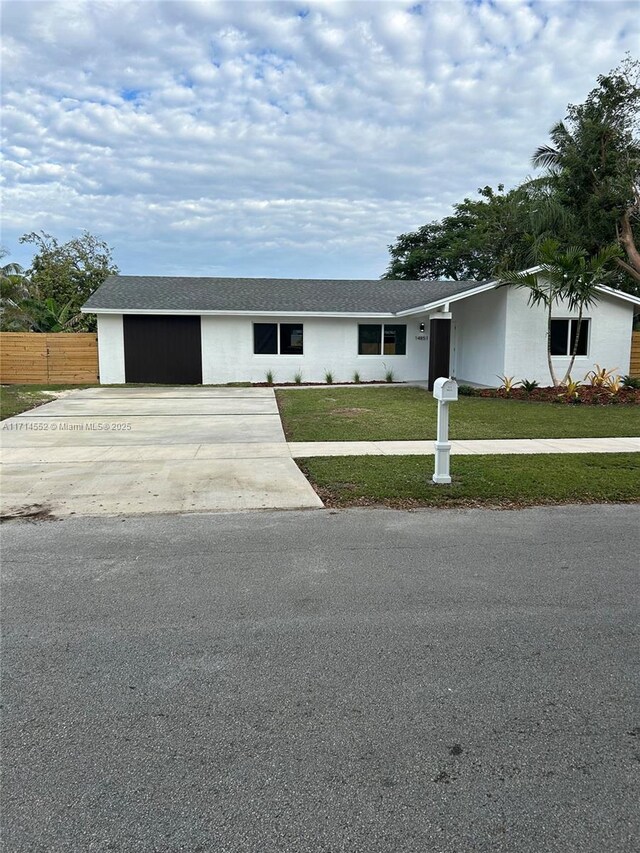 ranch-style house with a front lawn