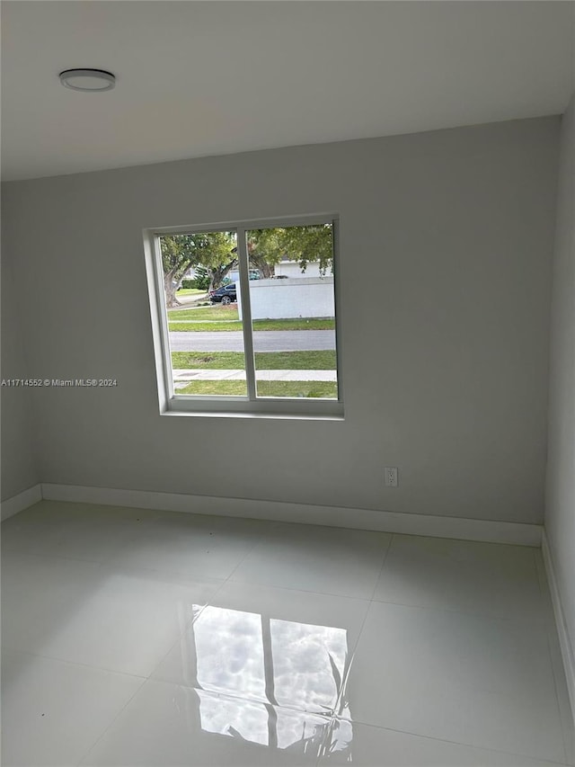 spare room with tile patterned floors