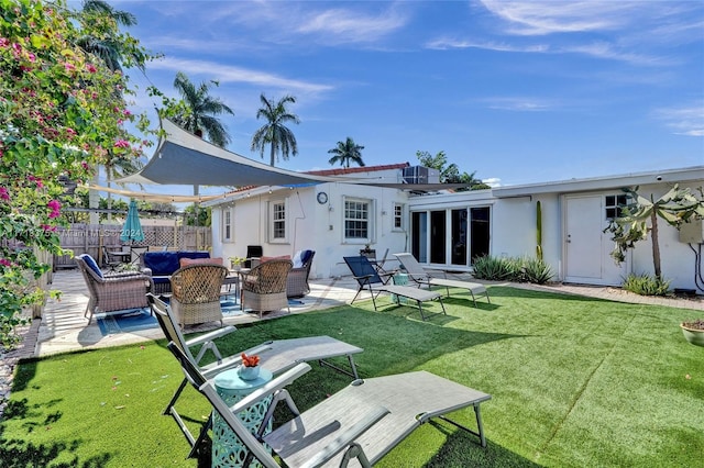 rear view of property featuring a lawn, outdoor lounge area, and a patio