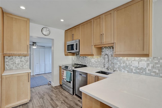 kitchen featuring ceiling fan, sink, light brown cabinetry, appliances with stainless steel finishes, and light wood-type flooring