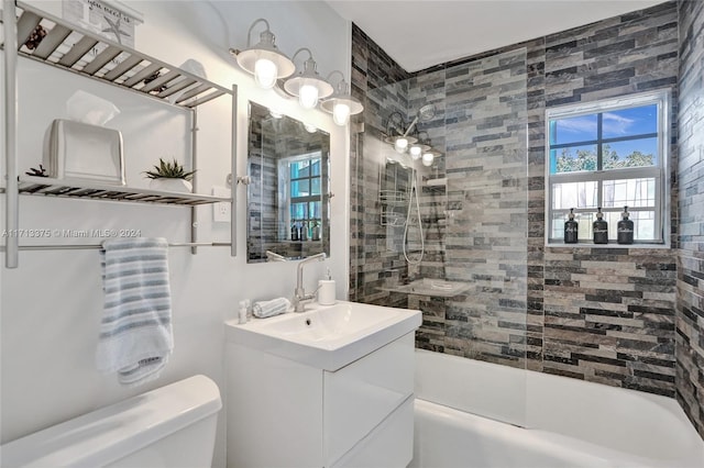 full bathroom featuring vanity, toilet, and tiled shower / bath