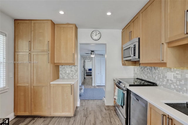 kitchen with ceiling fan, light hardwood / wood-style floors, stainless steel appliances, and light brown cabinetry