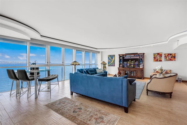 living room with a water view and expansive windows