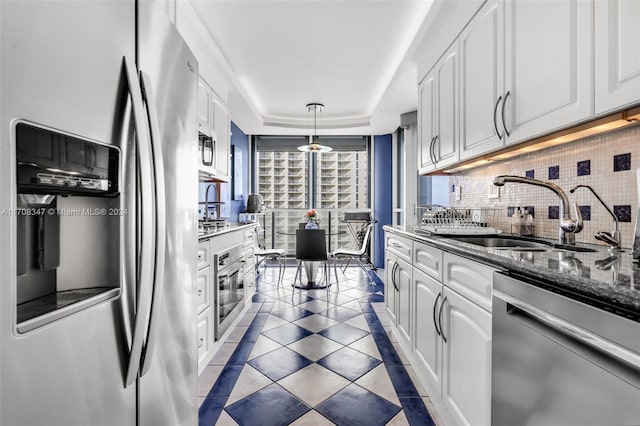 kitchen with sink, white cabinets, pendant lighting, and appliances with stainless steel finishes