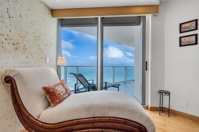 bedroom with access to outside, a water view, and multiple windows